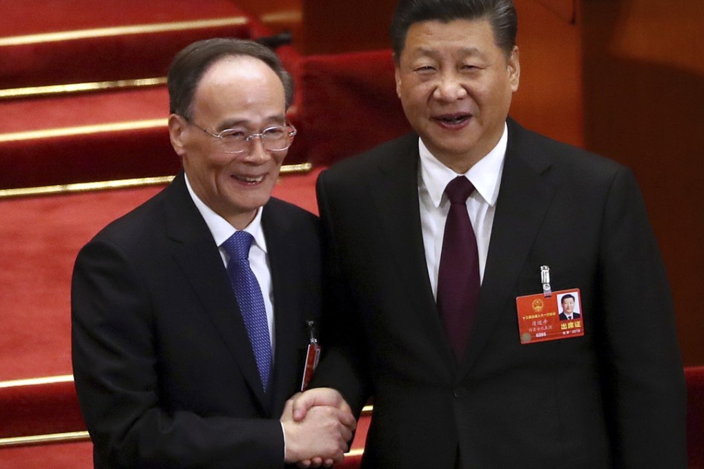 Xi Jinping (right) shakes hands with Wang Qishan after Wang was elected vice-president in Beijing on Saturday. Photo: AP
