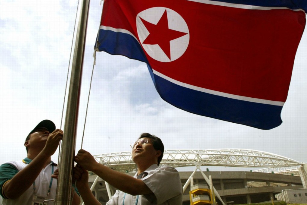 The North Korea national flag is hoisted in front of the main stadium in Daegu. Photo: AFP