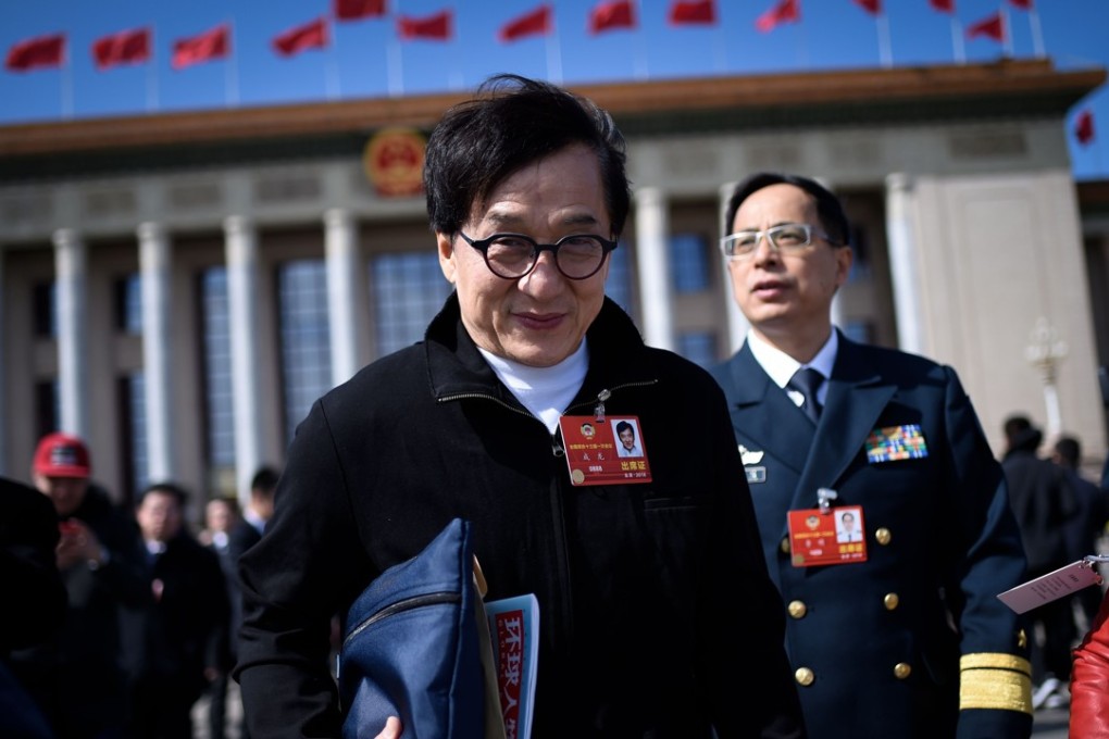Hong Kong actor Jackie Chan leaves after the closing session of the Chinese People's Political Consultative Conference (CPPCC) outside the Great Hall of the People in Beijing on Thursday. Chan is fighting to remove a restriction that requires Hong Kong-mainland co-productions to share a third of their talent with the mainland. Photo: AFP