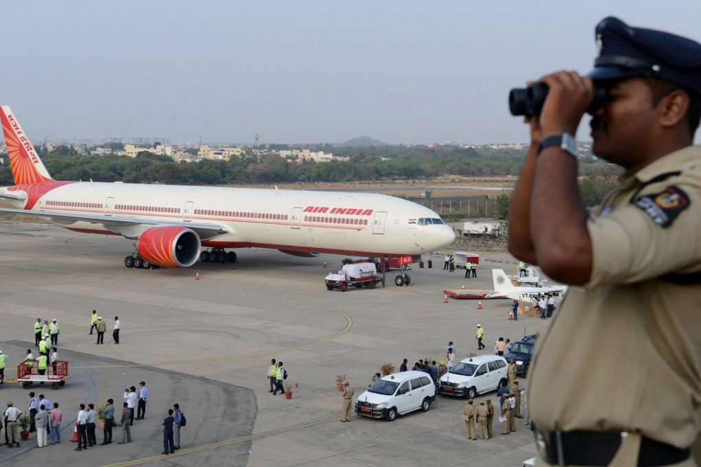 File photo of an Indian policeman watching over Begumpet Airport. Photo: AFP