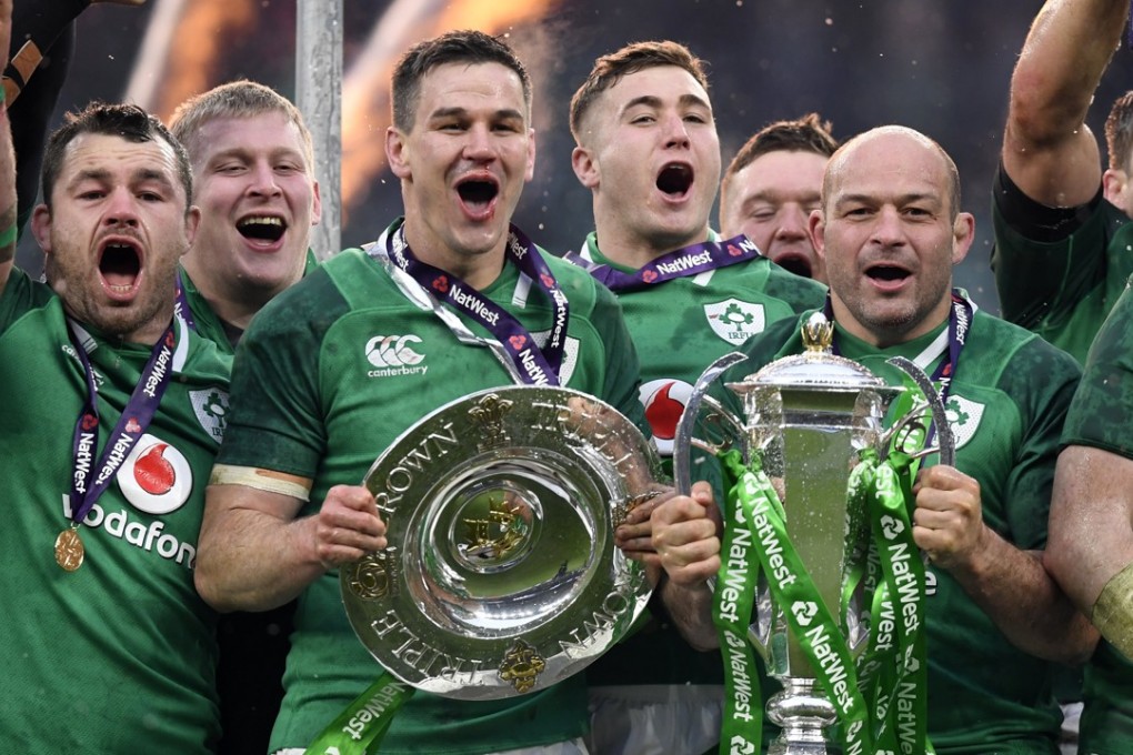 Ireland’s Johnny Sexton (centre left) and captain Rory Best (right) celebrate with the Six Nations trophy and Triple Crown Trophy after Ireland beat England. Photo: EPA