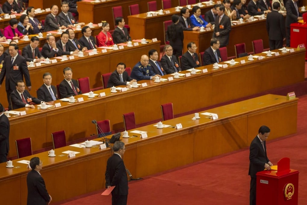 National People’s Congress delegates line up to cast their ballots at the Great Hall of the People in Beijing on Sunday. Photo: Bloomberg
