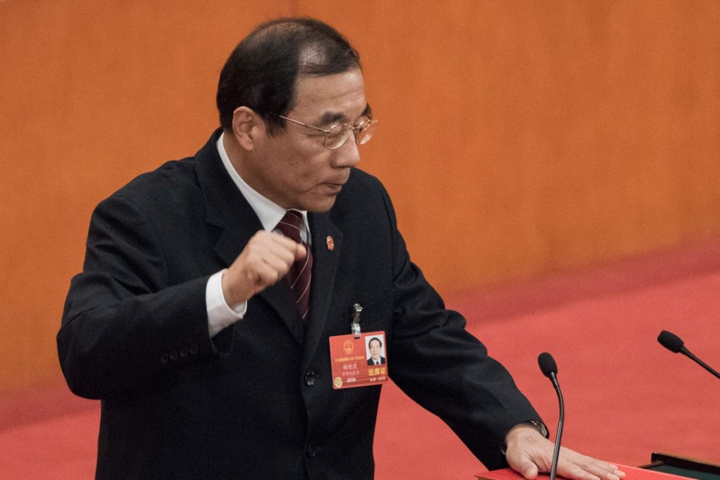 Yang Xiaodu takes an oath after being elected director of the new National Supervisory Commission at the Great Hall of the People in Beijing on Sunday. Photo: AFP