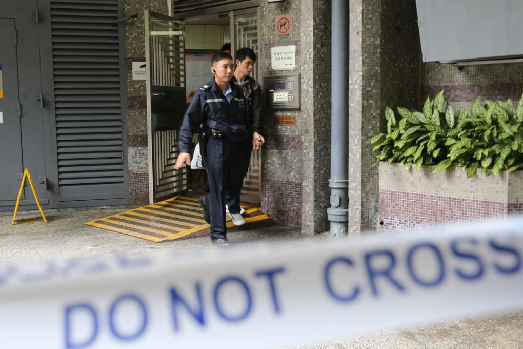 Police officers exit Mau Lam House, Kwong Lam Court, earlier this month. That was the building where two other police officers were injured when a drunk man snatched a gun from one of them. Photo: Dickson Lee