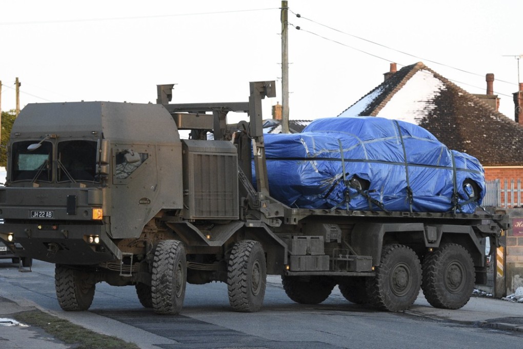 A vehicle wrapped in blue tarpaulin is removed from Larkhill Road in Durrington, a few kilometres north of Salisbury, England, on the back of an Army truck, on March 19, 2018, as the investigation into the suspected nerve agent attack on Russian double agent Sergei Skripal and his daughter Yulia continues. Photo: PA via AP