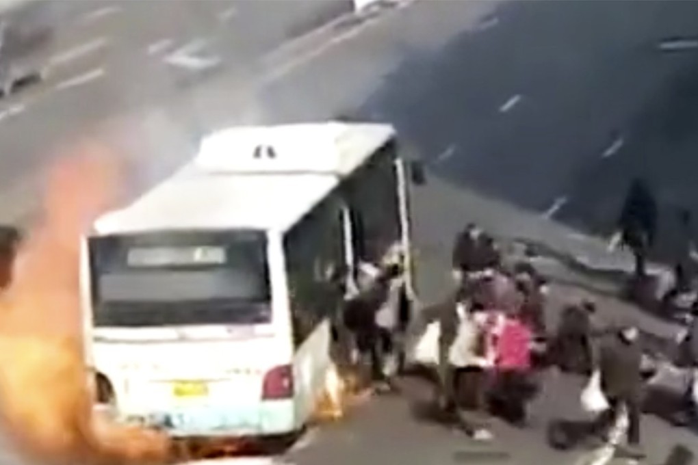 Chaos broke out aboard a Harbin bus that caught fire and burnt on a downtown street, injuring at least three passengers. Photo: Photo: Weibo