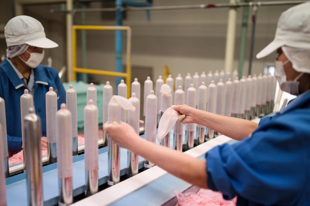 Employees of Japanese condom maker Sagami perform quality tests on randomly picked condoms. Photo: AFP