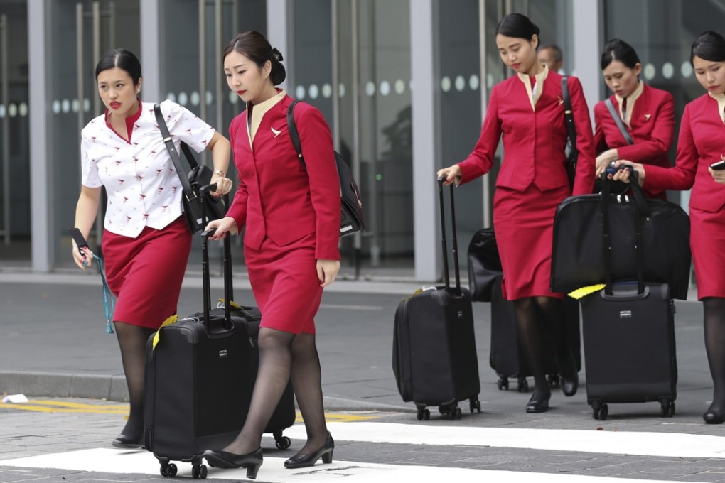 Staff at Cathay Pacific are pushing for women to be allowed to wear trousers, as with many other international airlines. Pictured: some Cathay flight attendants at Hong Kong International Airport in May last year. Photo: Edward Wong
