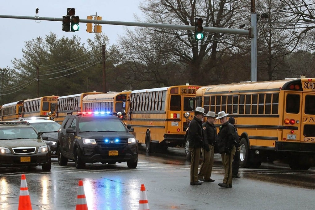 School buses and police in front of Great Mills High School. Photo: AFP
