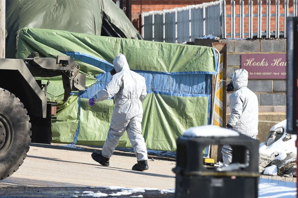 Police in protective suits exit a yard on Larkhill Road in Durrington, Salisbury, England on Monday, as the investigation into the suspected nerve agent attack on Russian double agent Sergei Skripal and his daughter Yulia continues. Photo: PA Wire/Abaca Press via TNS