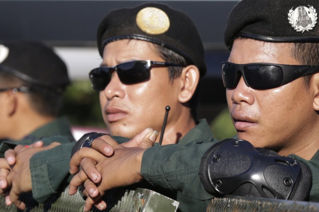 Cambodian police officers stand guard on a street near the Supreme Court in Phnom Penh. Dozens of opposition lawmakers were banned when Cambodia’s Supreme Court dissolved the CNRP last year in a ruling that was widely condemned by the international community. File photo: EPA