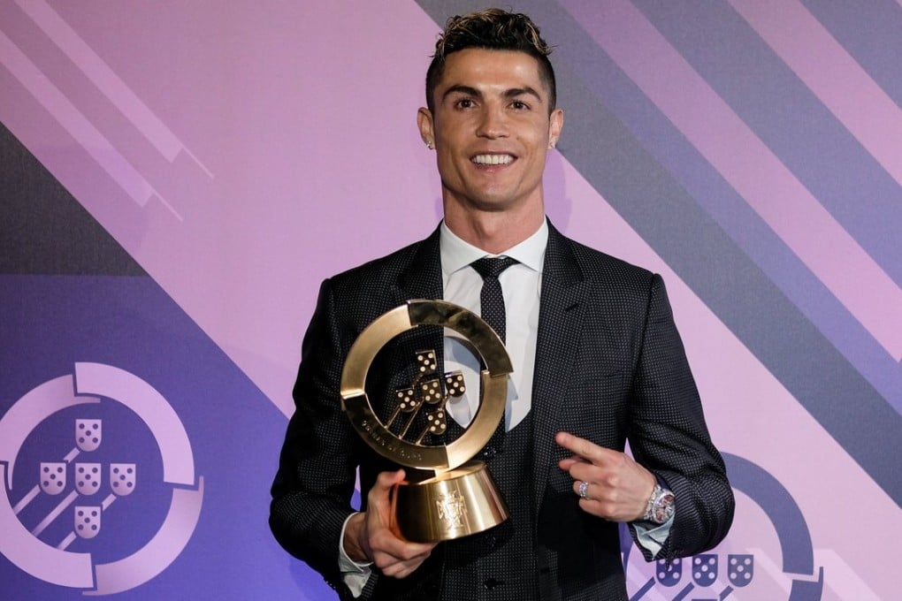 Real Madrid star Cristiano Ronaldo of Portugal holds the trophy for player of the year during a ceremony of the Portuguese Soccer Federation (FPF). Photo: EPA