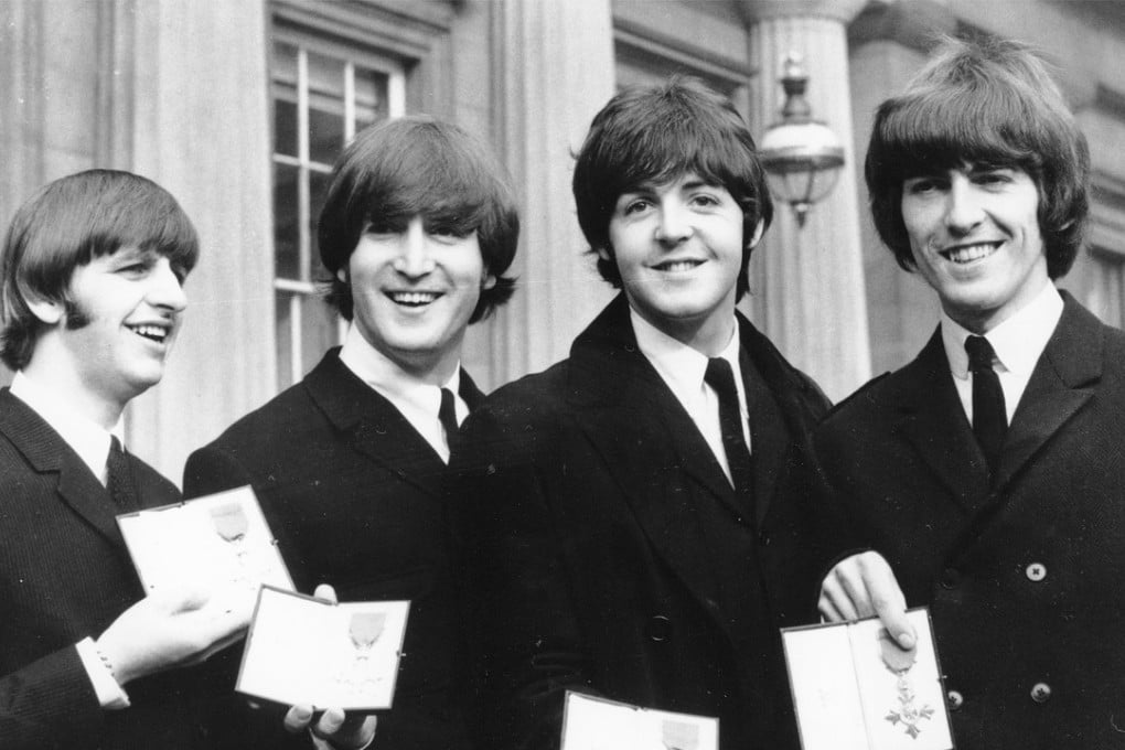 In this Oct. 26, 1965 file photo, The Beatles, from left: Ringo Starr, John Lennon, Paul McCartney and George Harrison, smile as they display the Member of The Order of The British Empire medals presented to them by Queen Elizabeth II in a ceremony in Buckingham Palace in London, England. Photo: AP