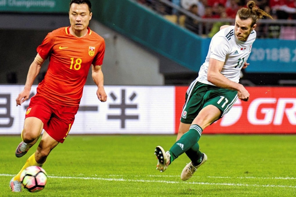Wales superstar Gareth Bale gets a shot in against China in Nanning. Photos: Reuters