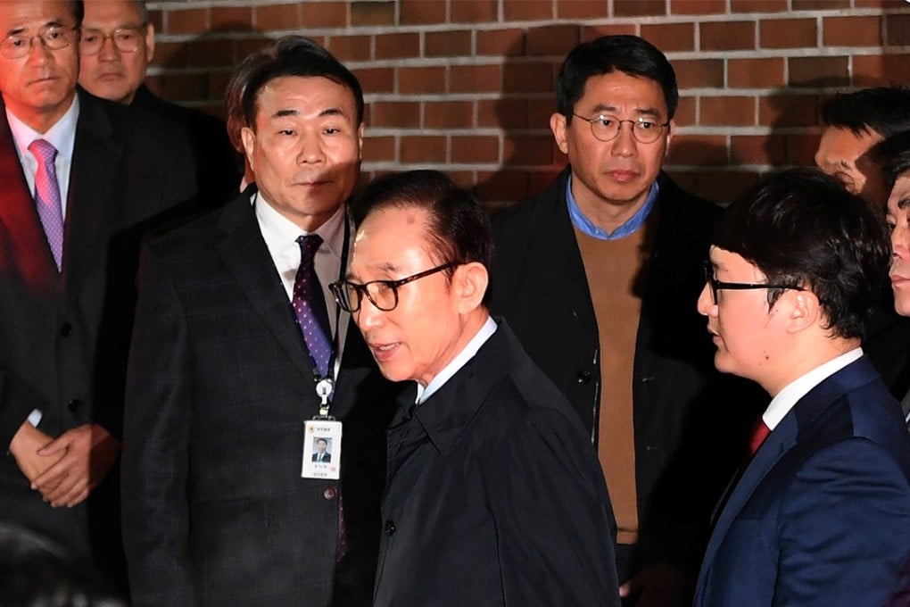 Former South Korean president Lee Myung-bak gets in a car as he is transferred to a detention centre from his residence in Seoul, South Korea, on Thursday. Photo: Pool via Reuters