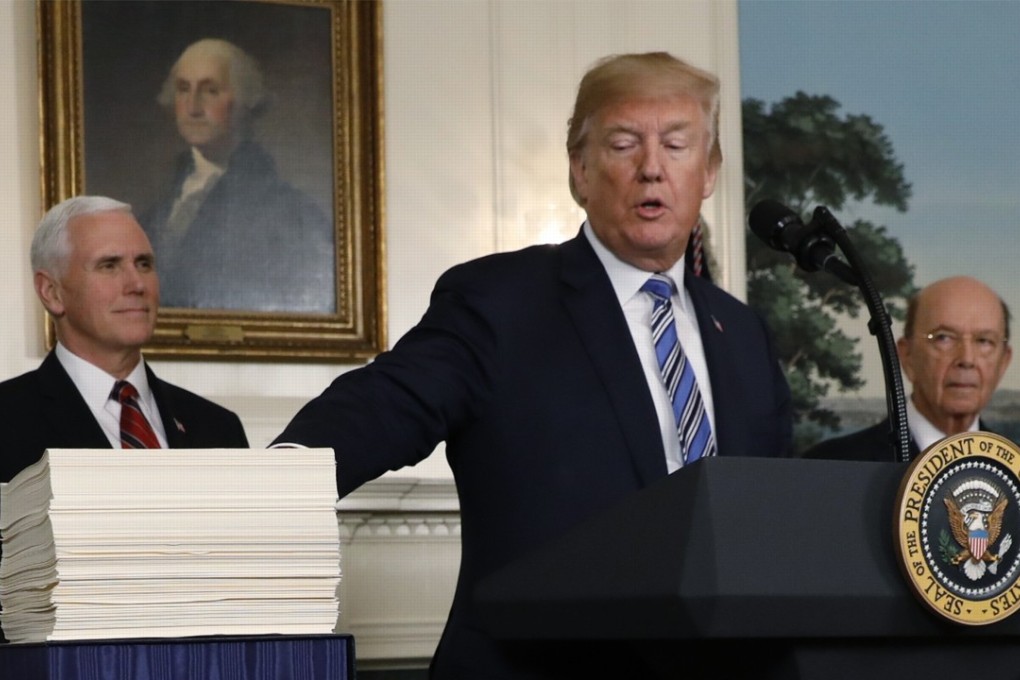 US President Donald Trump points to Congress' US$1.3 trillion spending bill during a signing ceremony in the Diplomatic Room of the White House on Friday. Photo: Reuters