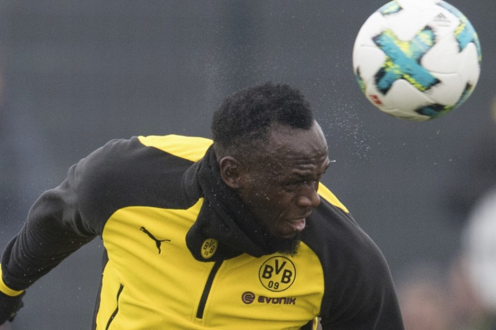 Jamaica’s former sprinter Usain Bolt heads the ball during a practice session with the Borussia Dortmund soccer squad. Photo: AP