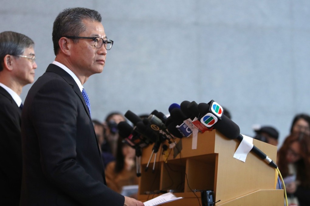 The city’s welfare minister Dr Law Chi-kwong (left), and finance chief Paul Chan (right) announce the cash handout for 2.8 million Hongkongers on Friday. Photo: Sam Tsang