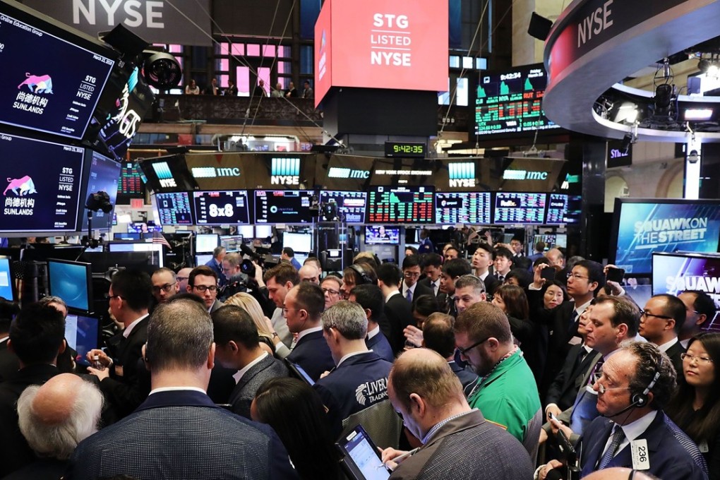 Traders gathered on the floor of the New York Stock Exchange (NYSE). American companies such as Apple, Boeing could be hit by China US trade war, Chinese state media warned.