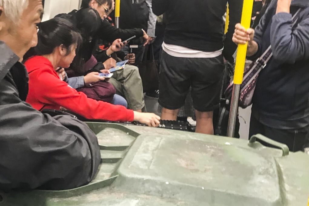 The online photo of the man with his rubbish bin on the MTR went viral. Photo: Handout