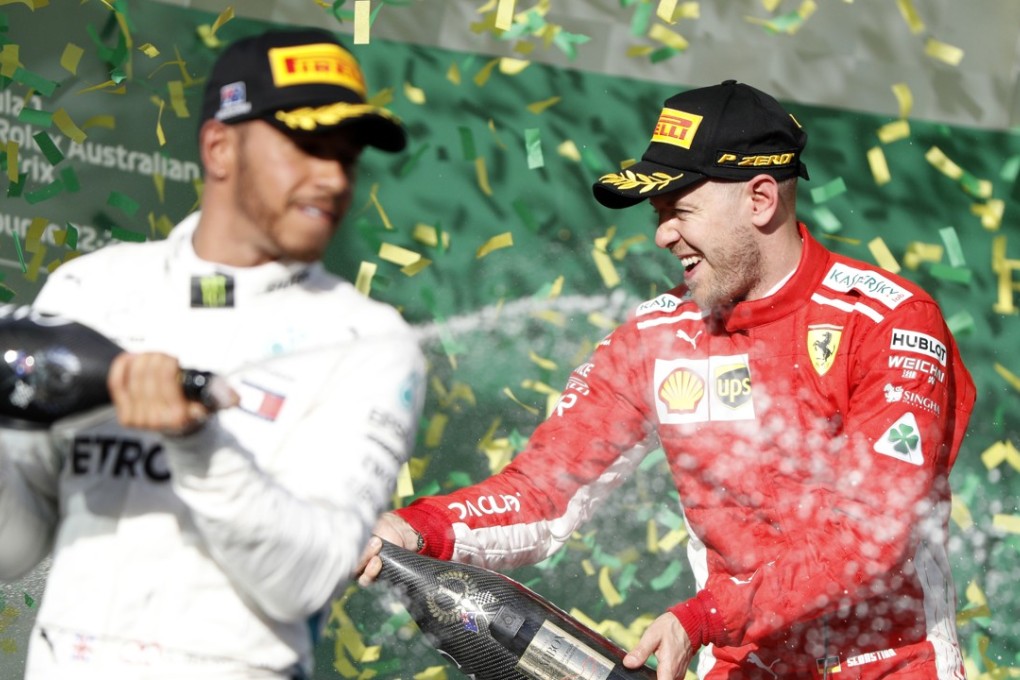 Ferrari driver Sebastian Vettel (right), of Germany, and Mercedes driver Lewis Hamilton, of Britain, spray champagne after the first race of the season at the Australian Formula One Grand Prix in Melbourne. Photo: AP