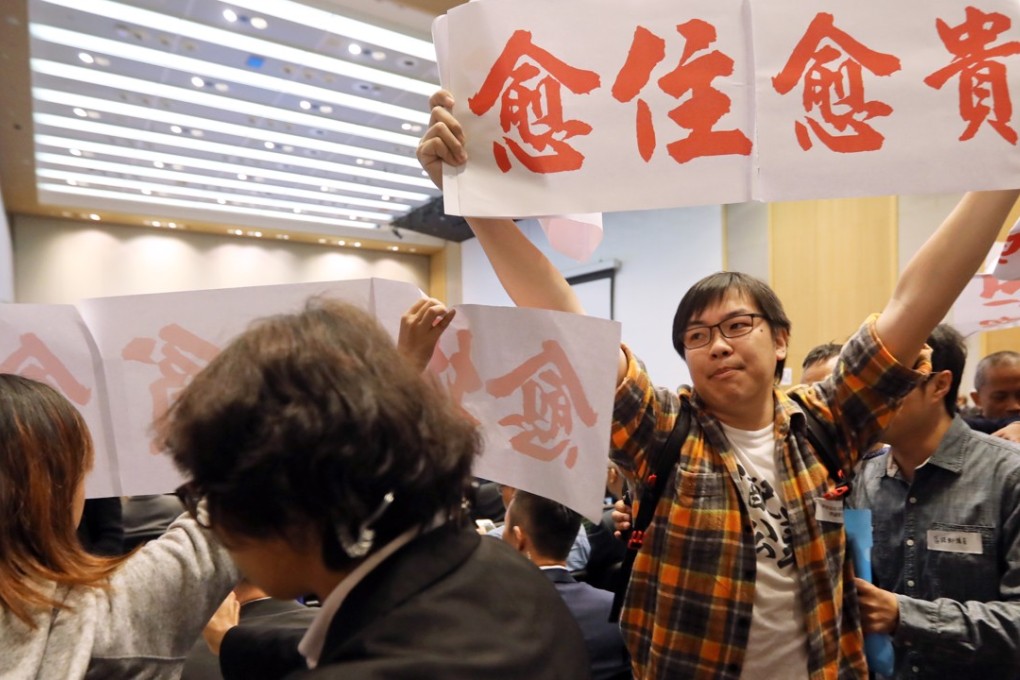 Protesters outside the Commission on Poverty summit in Tamar. Photo: Edward Wong