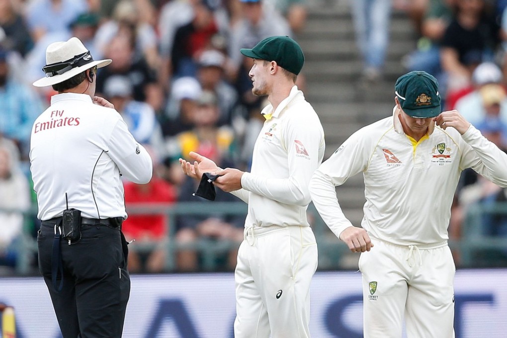 Australian fielder Cameron Bancroft (R) is questioned by Umpires Richard Illingworth (L) and Nigel Llong (not in picture) during the third day of the third Test cricket match between South Africa and Australia at Newlands cricket ground on March 24, 2018 in Cape Town. The Australians confessed to tampering with the ball during the match. Photo: AFP