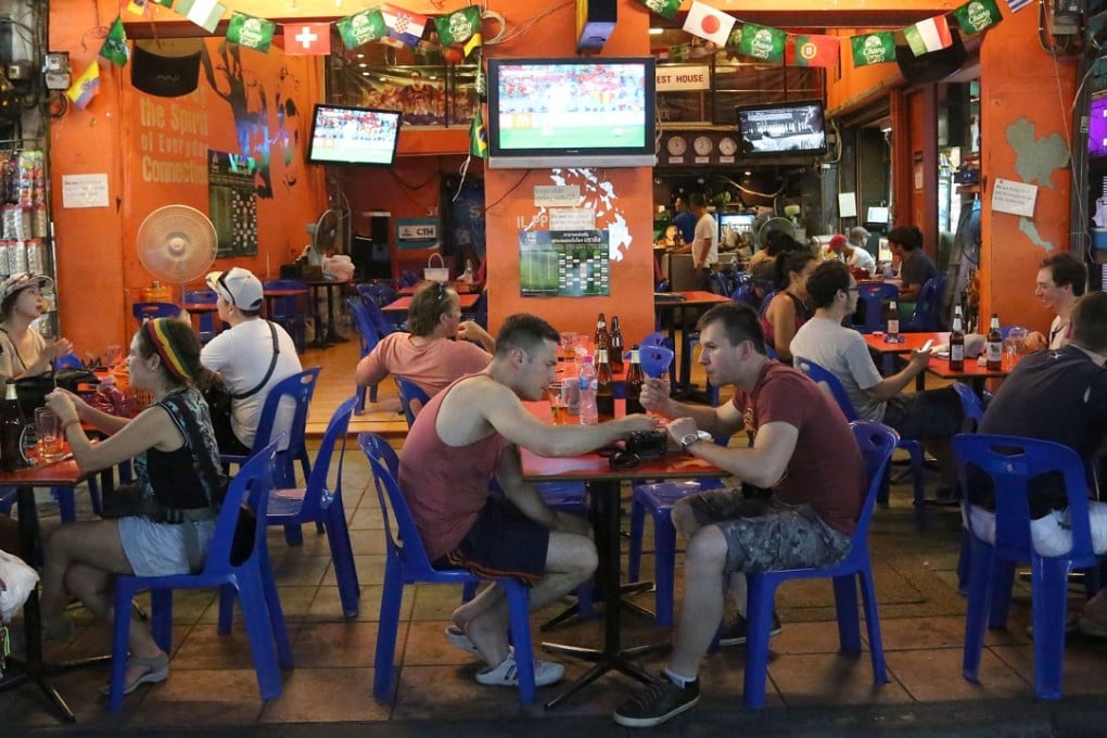 Tourists and locals eat and drink at a restaurant on Bangkok’s Khaosan road. The city’s notorious nightlife is under threat, according to some, as the military government embarks on a crackdown on late-night venues. Photo: AP