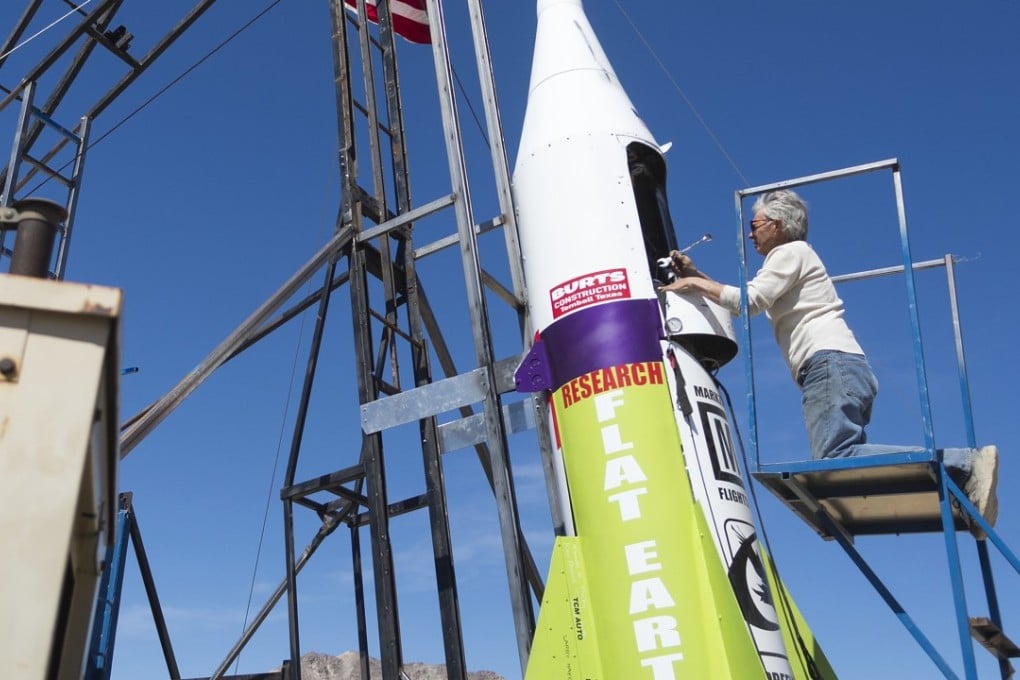 Mike Hughes repairs a steam leak on his home-made rocket after a previously cancelled launch. But on Saturday, he blasted himself about 1,875 feet into the air before a hard landing in the Mojave Desert. Photo: AP