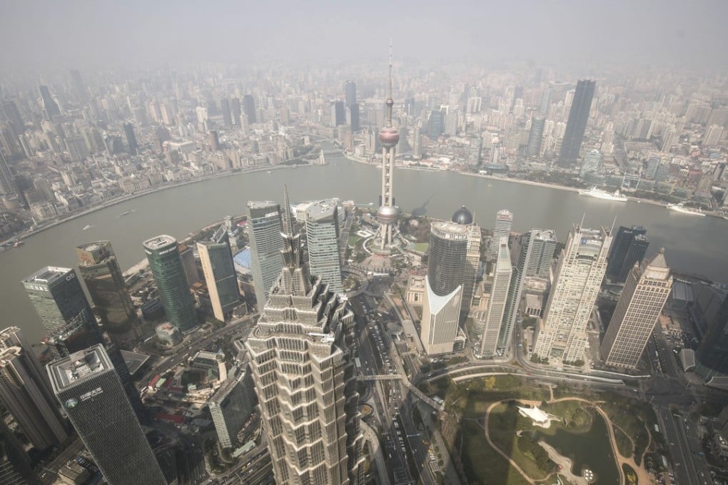 The Jin Mao Tower, foreground, and the Oriental Pearl Tower, centre, and other buildings seen from the Shanghai World Financial Center. Photo: Bloomberg