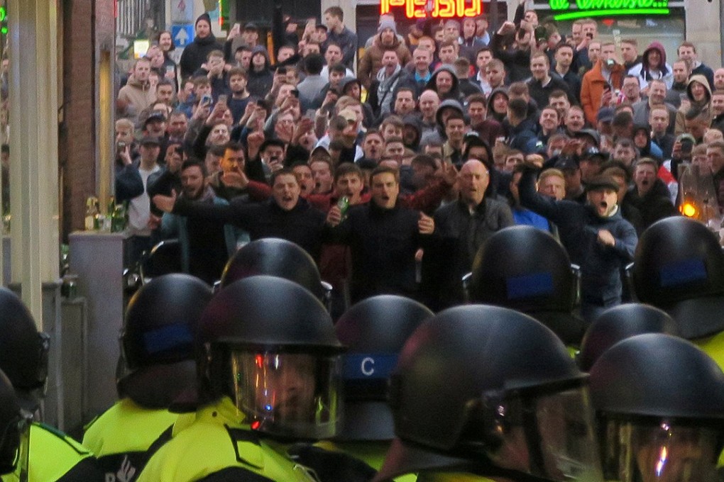 England fans and Police face off in Amsterdam as clashes ensue. Photo: Reuters
