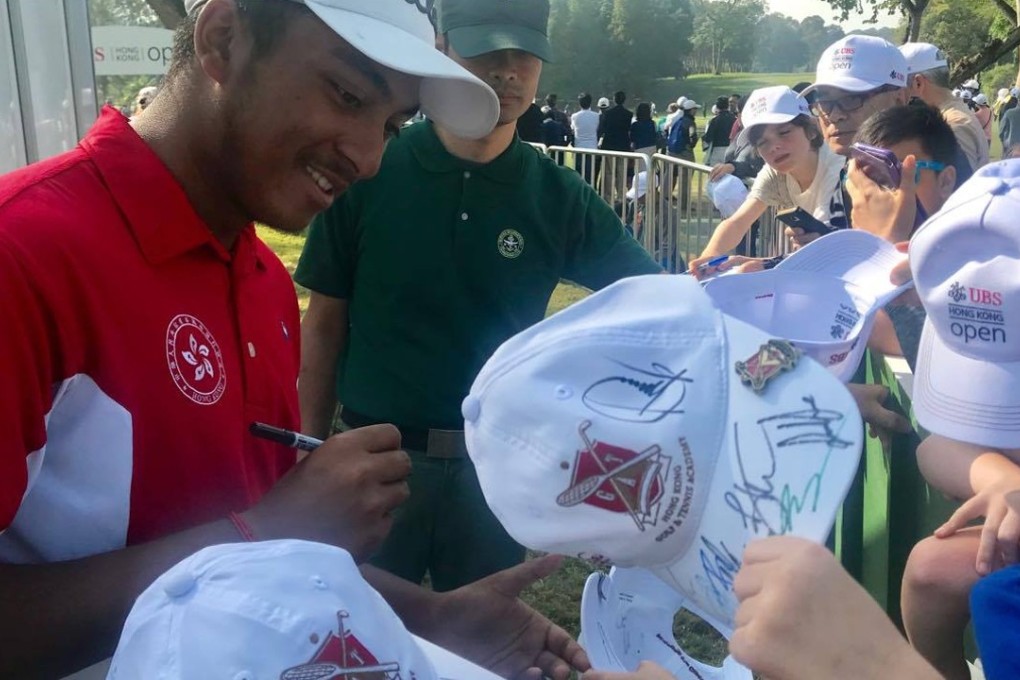 Amateur local golfer Leon D’Souza signs autographs for young fans at the UBS Hong Kong Open, at the Hong Kong Golf Club in Fanling last November. There has been debate about developing one of the three golf courses at the club for housing. Photo: Andrew McNicol