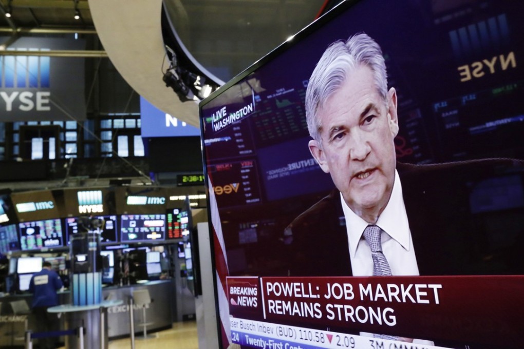 The Washington news conference of Federal Reserve Chairman Jerome Powell appears on a television on the floor of the New York Stock Exchange. Photo: AP