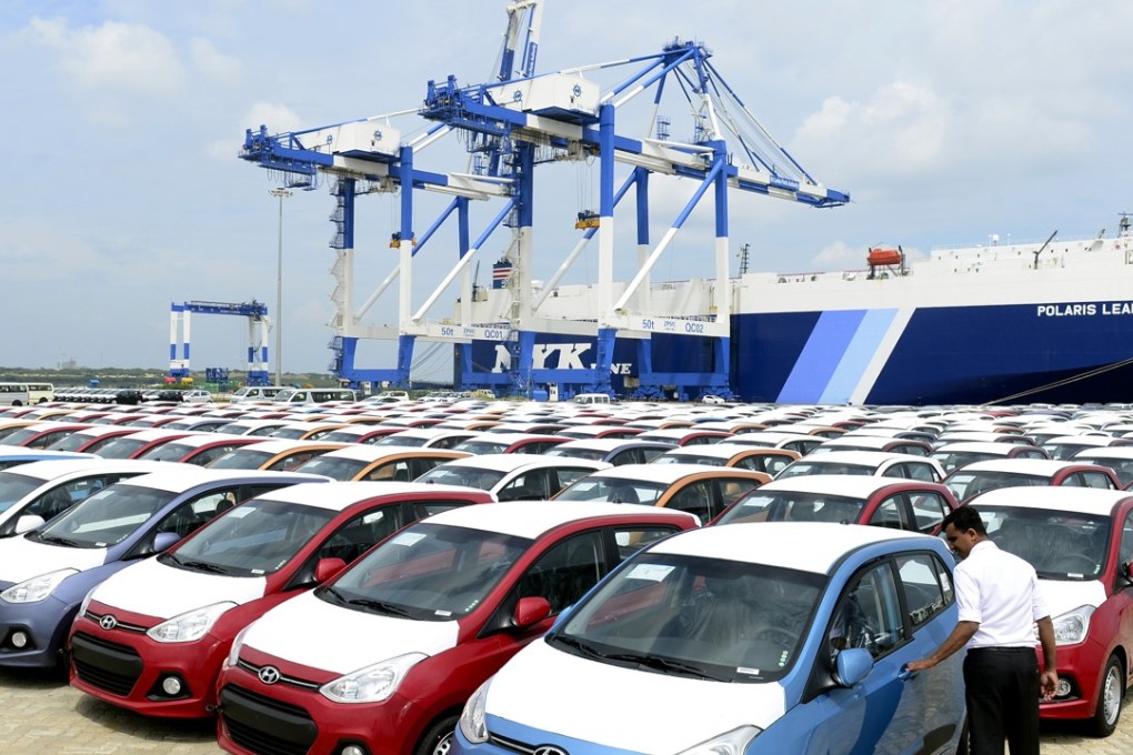 A Sri Lankan official inspects cars at the port facility at Hambantota. Photo: AFP