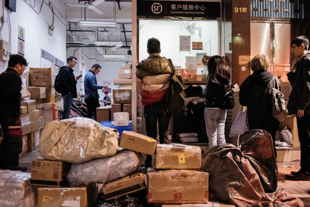 Customers line up outside an SF Express shop in February last year. Parent SF Holding said it has won a licence to operate drones in mainland China. Photo: Bloomberg