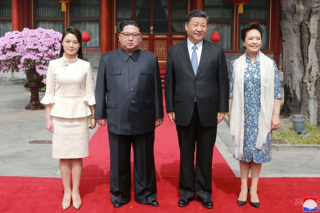 North Korea’s first lady Ri Sol-ju (left) wore a two-piece ivory-coloured dress for a lunch with Xi Jinping and China’s first lady Peng Liyuan. Photo: Reuters