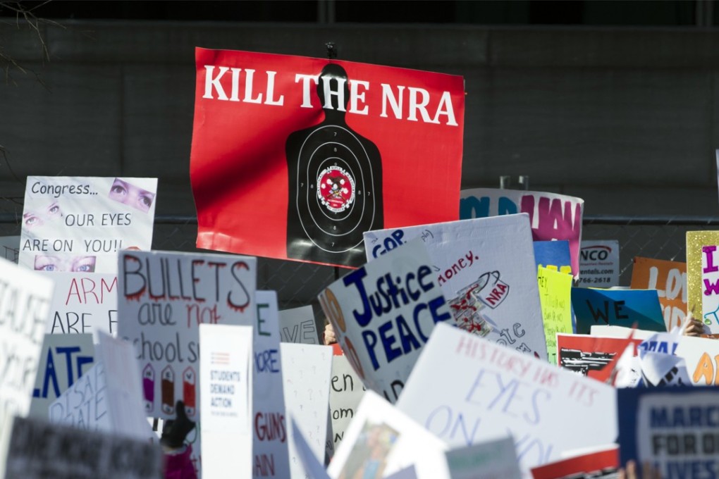 Protesters hold anti-NRA signs as they attend the "March for Our Lives" rally in support of gun control in Washington on Saturday. Photo: AP