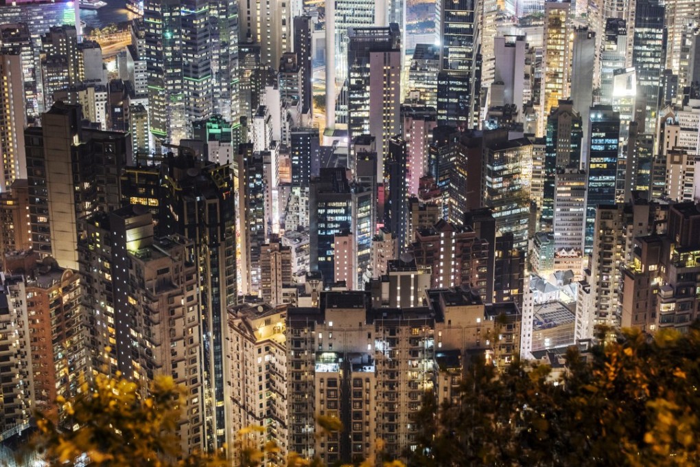 Residential and commercial buildings lit up at night in Hong Kong. Photo: Bloomberg