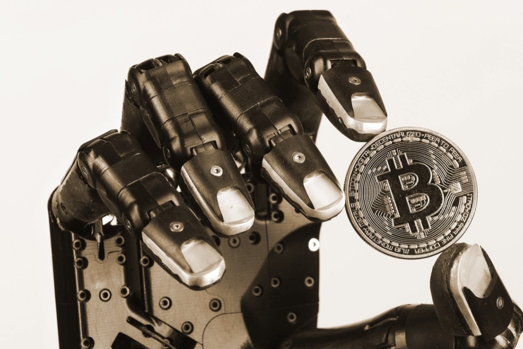 The “Shadow Dexterous” robotic hand, manufactured by The Shadow Robot Company, holds a coin representing the bitcoin cryptocurrency, during a demonstration of its agility in February in London. Photo: Bloomberg