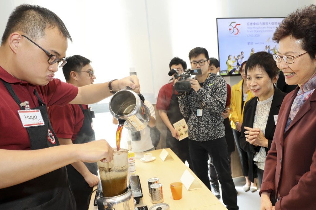 Chief Executive Carrie Lam Cheng Yuet-ngor watches an autistic student making milk tea during her visit to the Heep Hong Society Intregrated Services Building in Pok Fu Lam. Photo: Handout