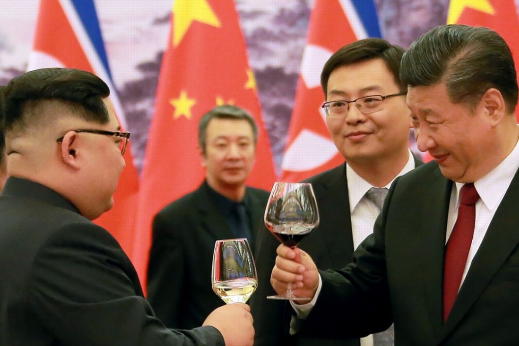 Chinese President Xi Jinping and North Korean leader Kim Jong-un raise their glasses at the Great Hall of the People in Beijing on March 26, 2018. Photo: AFP/KCNA via KNS
