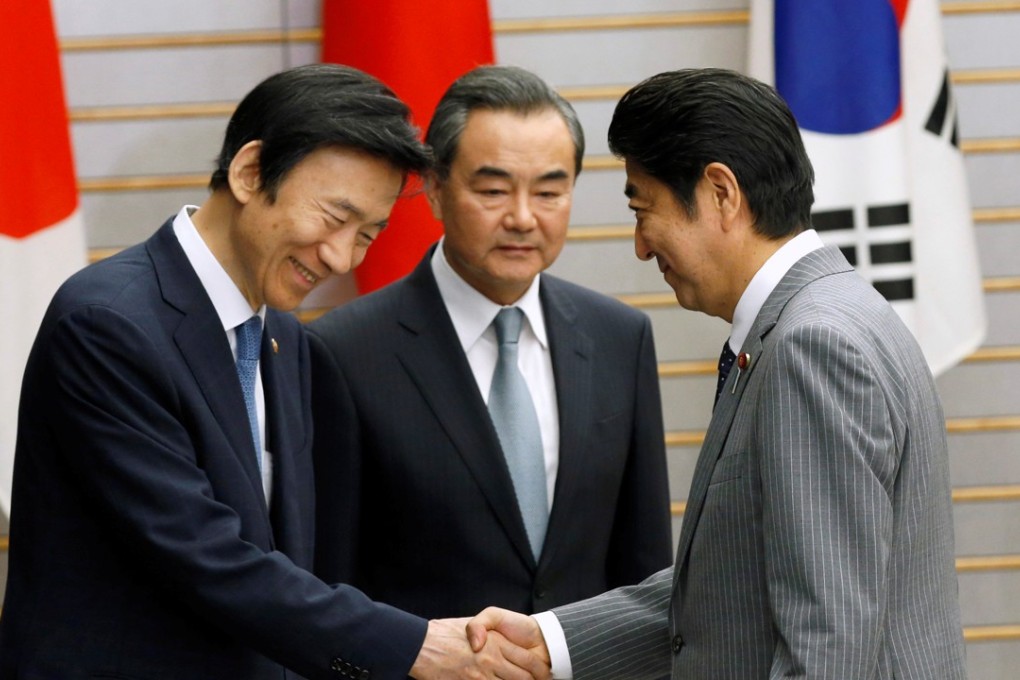 Japanese Prime Minister Shinzo Abe (right) meets then South Korean foreign minister Yun Byung-Se (left) and Chinese Foreign Minister Wang Yi in Tokyo in 2016. Yun urged China to keep up the pressure on North Korea. Photo: Reuters