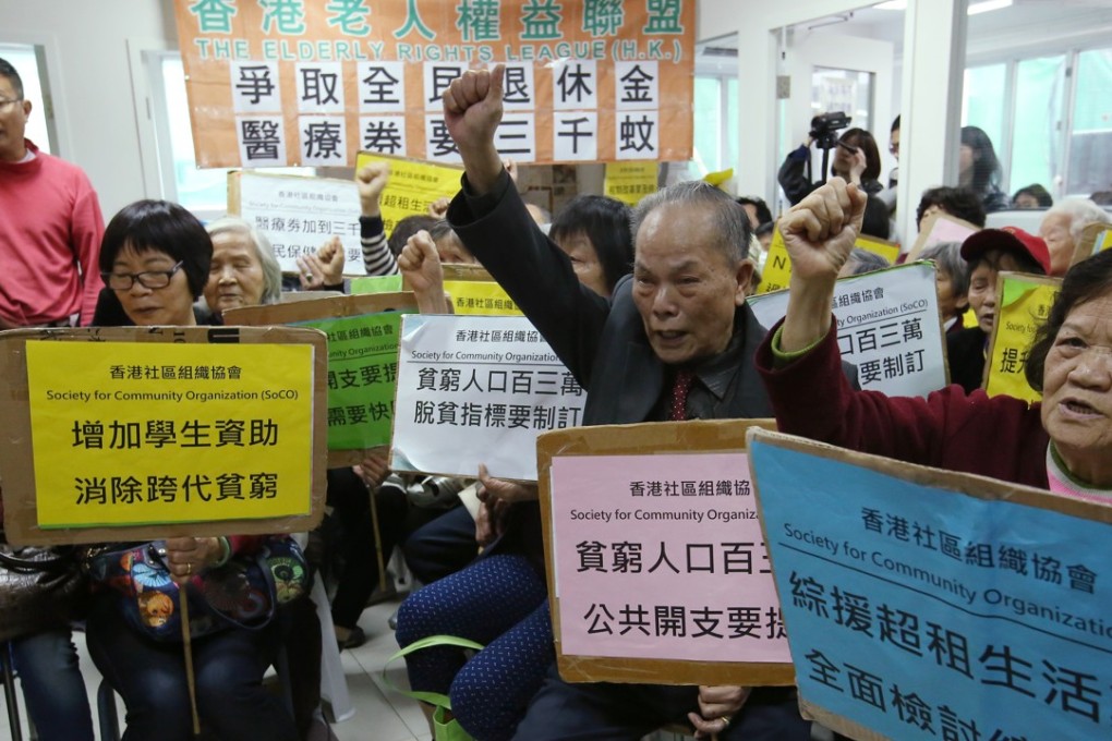 Members of the Hong Kong Society for Community Organisation and local residents watch a live broadcast of the budget speech, in Sham Shui Po on February 28. Photo: Edmond So