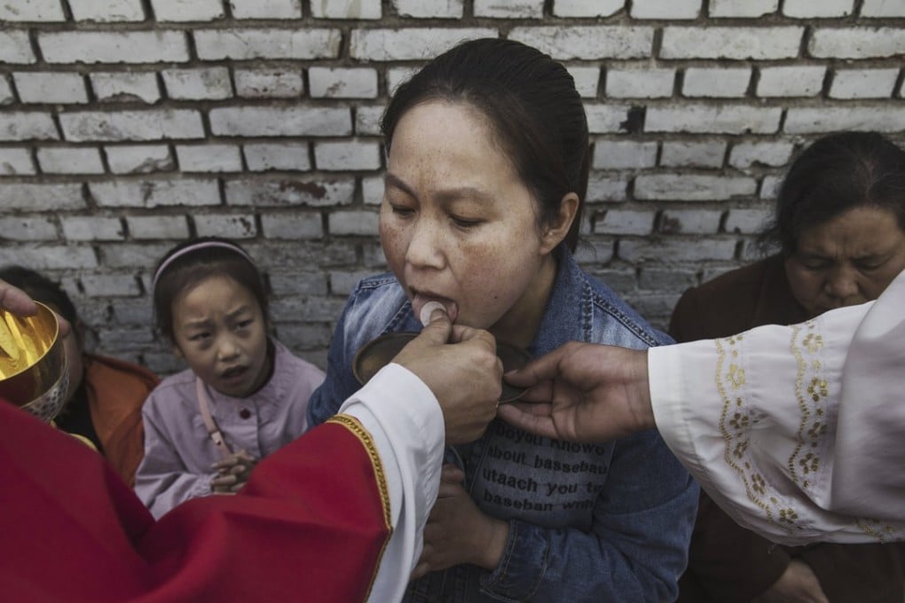 A worshipper receives communion at a service in an underground church last year. Photo: AFP/ Getty Images