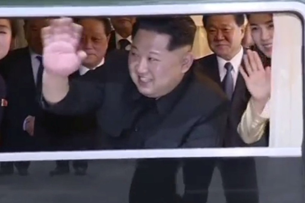 Kim Jong-un waves from the train as it leaves Dandong railway station in this still from the video. Photo: KRT via Reuters