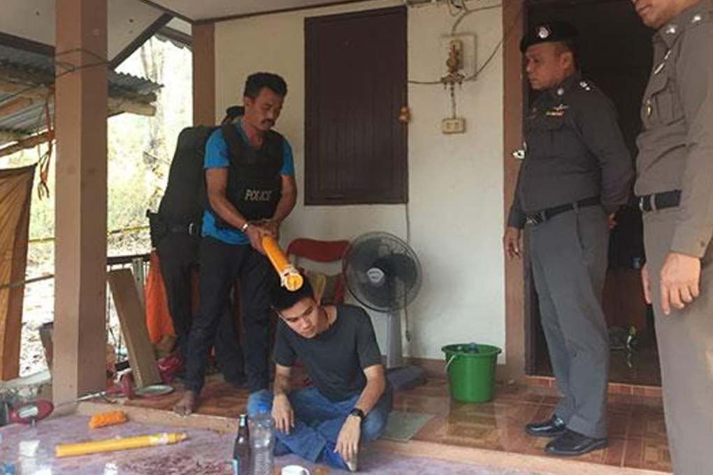 Murder suspect Makhata Seesai, 38, shows how he beat a 63-year-old monk to death with a large yellow candle in a fit of anger at a temple in Phitsanulok after they argued over a gambling debt. Photo: Chinnawat Singha/Bangkok Post