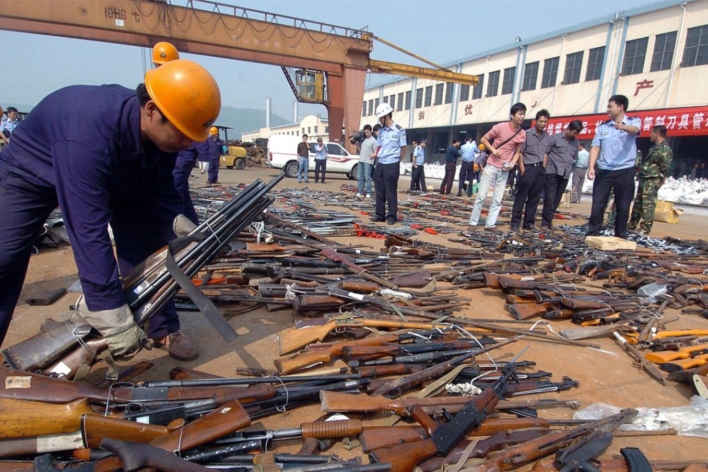 A series of controversial cases touched off criticism of the strictness and rigidity of standards used in China to distinguish toy firearms from real ones. Pictured: workers prepare illegal weapons for destruction at a yard in Ningbo, in eastern China's Zhejiang province. Photo: AFP