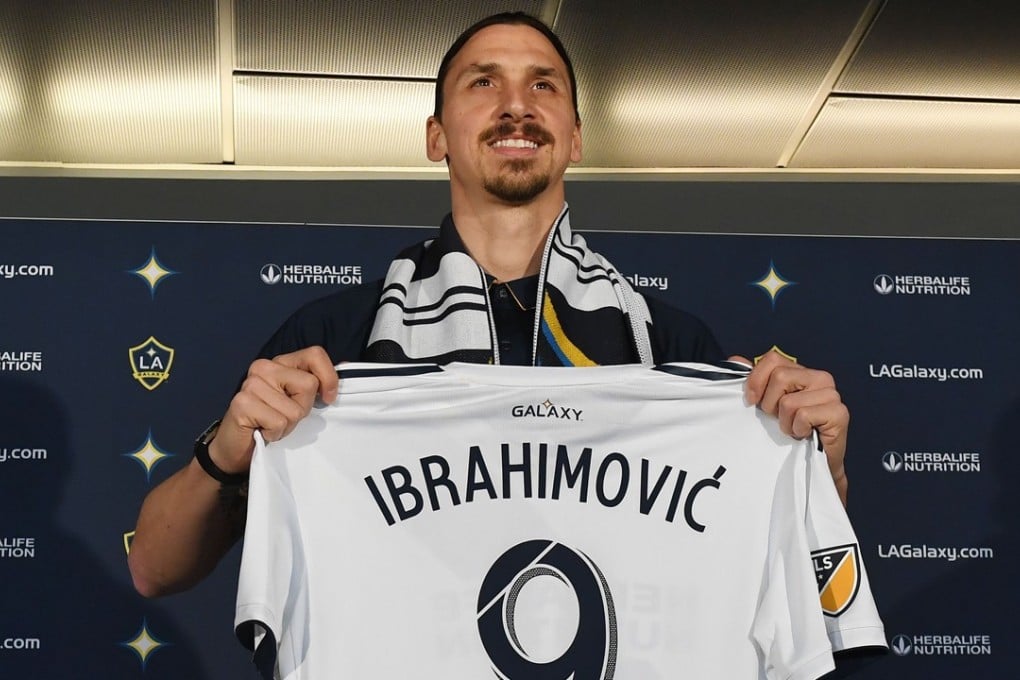 LA Galaxy footballer Zlatan Ibrahimovic holds up a team jersey during his first press conference for the club in Los Angeles. Photo: AFP