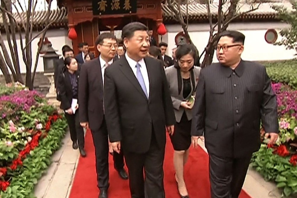 A still from Chinese state television shows President Xi Jinping (centre) talking to North Korean leader Kim Jong-un during his visit to Beijing. Photo: AFP