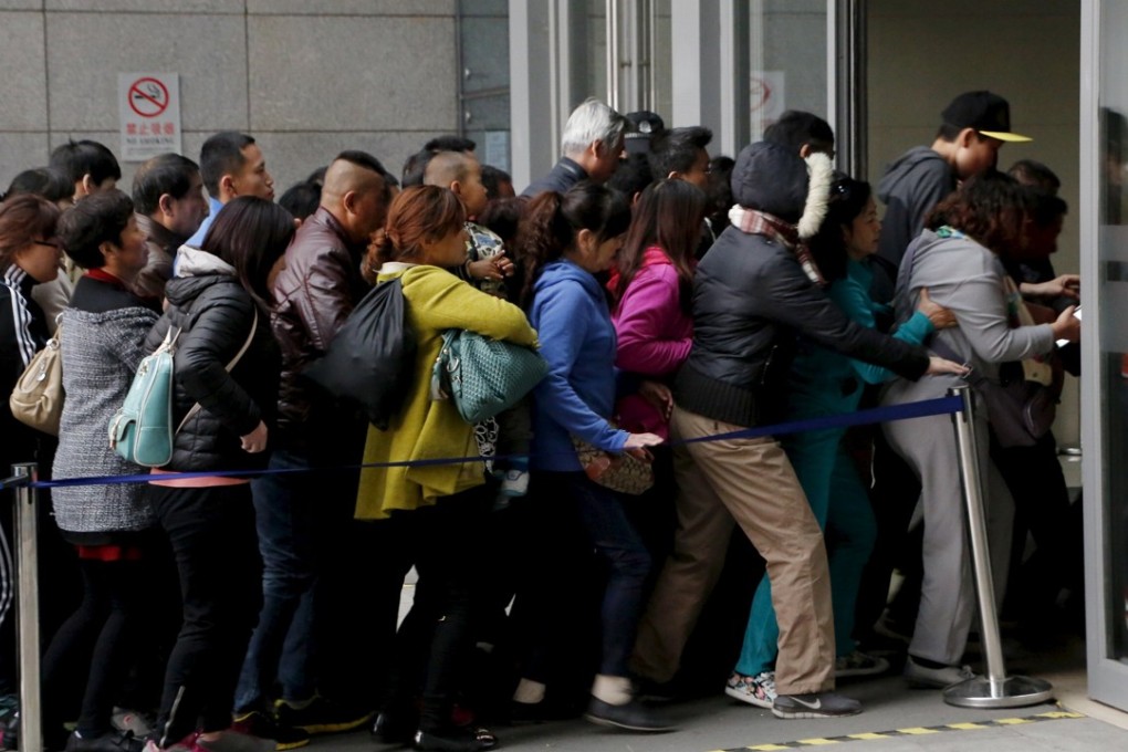 Patients rush into Peking Union Hospital in Beijing in this file photo from April 6, 2016. Elderly people in the long lines at service counters can only look on as younger Chinese used smartphones to process bookings in less than a minute. Photo: Reuters